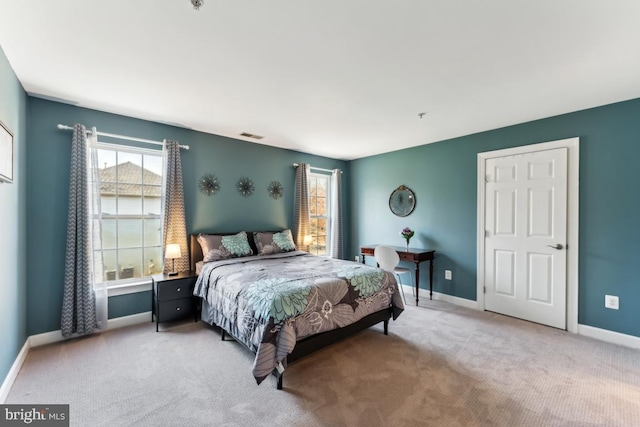 bedroom featuring light carpet