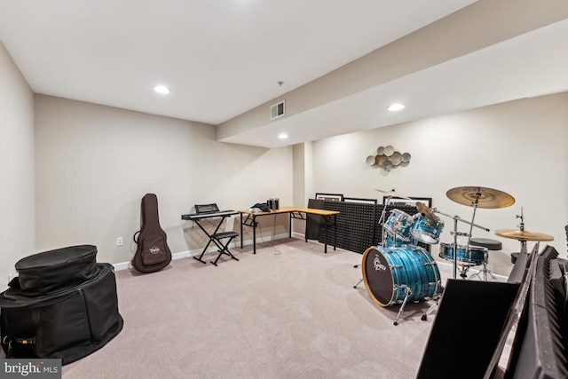 miscellaneous room featuring light colored carpet