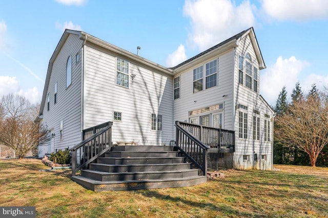 rear view of property with a yard and a deck