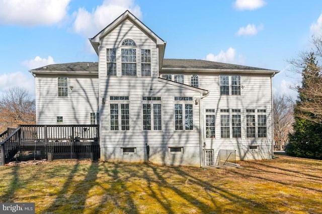 back of house featuring a wooden deck and a yard