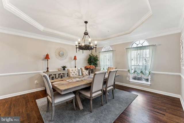 dining space with ornamental molding, a chandelier, and dark hardwood / wood-style flooring