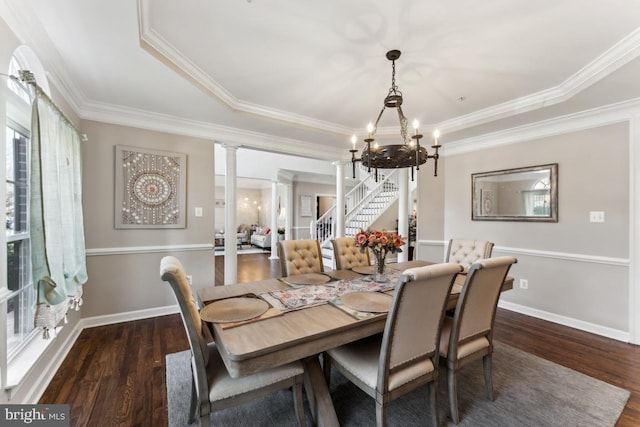 dining area with decorative columns, ornamental molding, dark hardwood / wood-style floors, and a notable chandelier