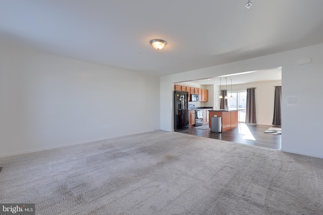 unfurnished living room with dark carpet