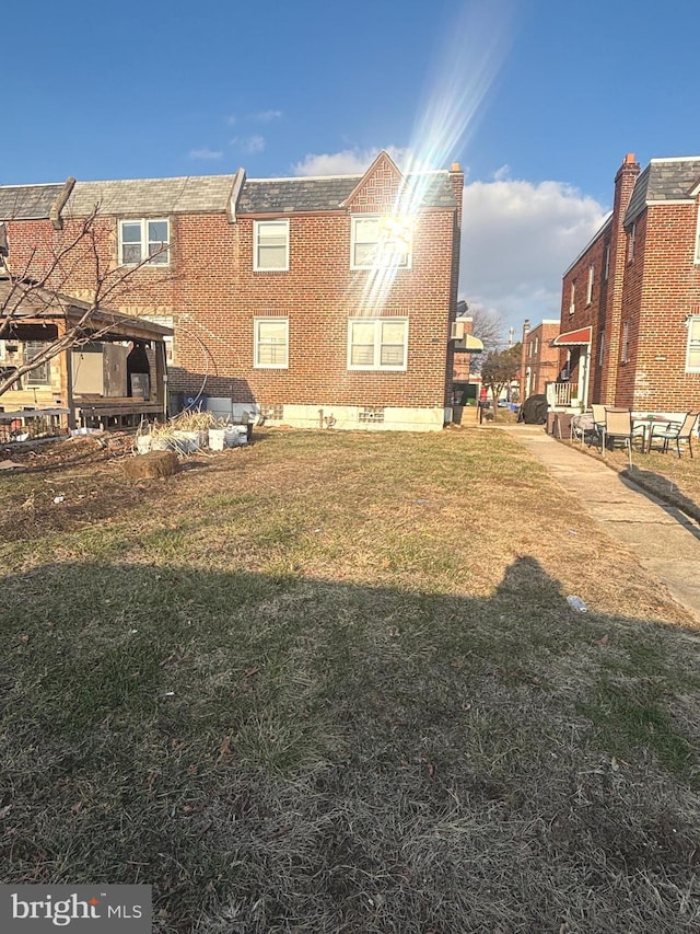 view of side of home featuring a lawn