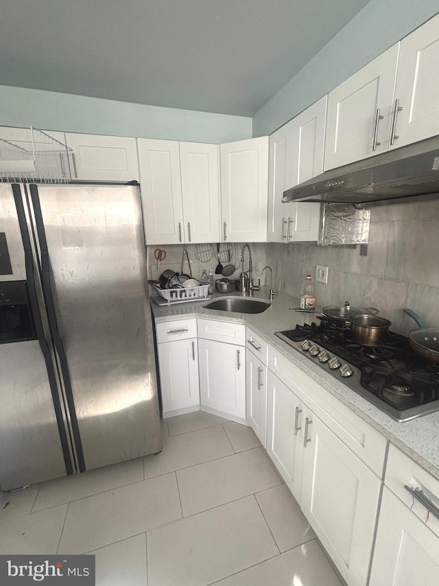 kitchen with stainless steel appliances, sink, and white cabinets