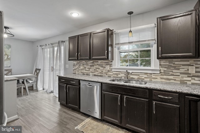 kitchen with dark brown cabinetry, sink, tasteful backsplash, dishwasher, and pendant lighting