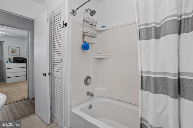 bathroom featuring tile patterned flooring and shower / tub combo