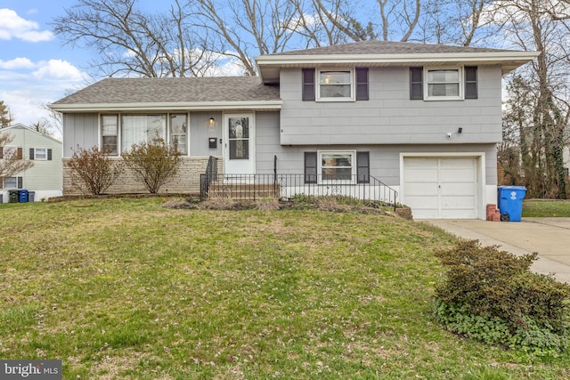 tri-level home featuring a garage and a front lawn