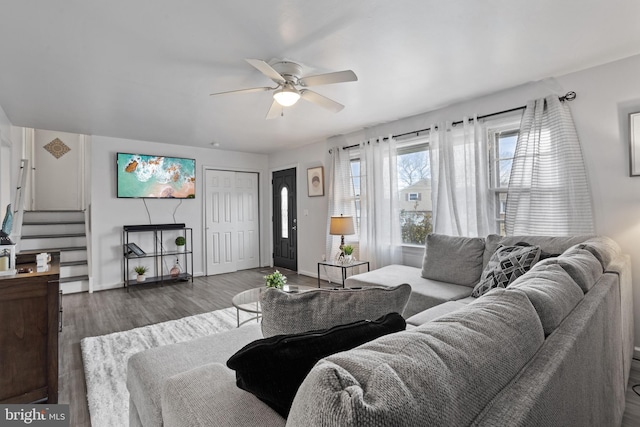 living room featuring dark hardwood / wood-style floors and ceiling fan