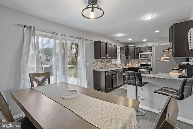 dining space featuring dark hardwood / wood-style flooring and sink