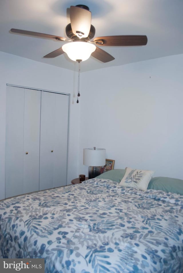 bedroom featuring ceiling fan and a closet