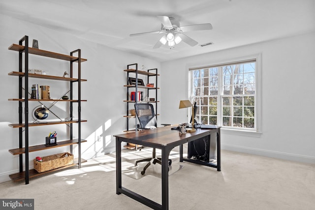 office space featuring ceiling fan and light colored carpet