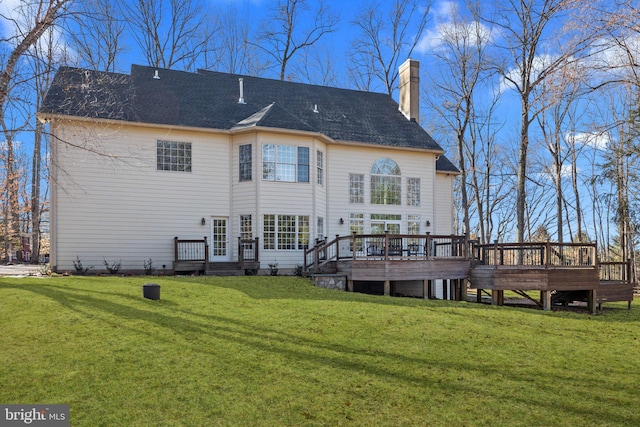 back of house with a wooden deck and a yard