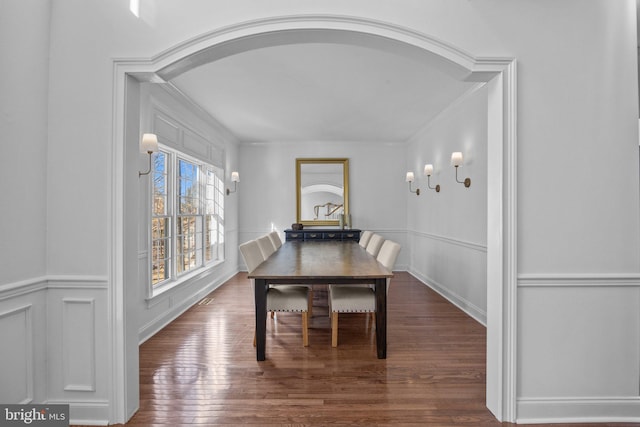 dining room featuring ornamental molding and dark hardwood / wood-style floors