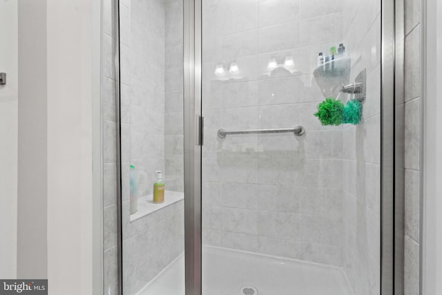 bathroom with a shower with shower door