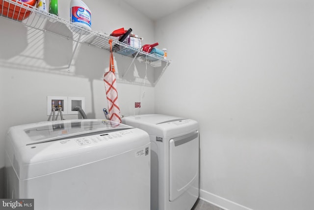 clothes washing area with independent washer and dryer