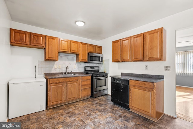 kitchen featuring stainless steel appliances, tasteful backsplash, and sink