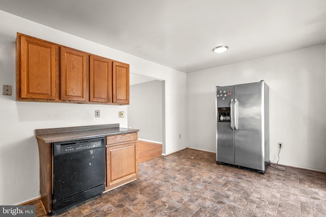 kitchen featuring stainless steel fridge and black dishwasher