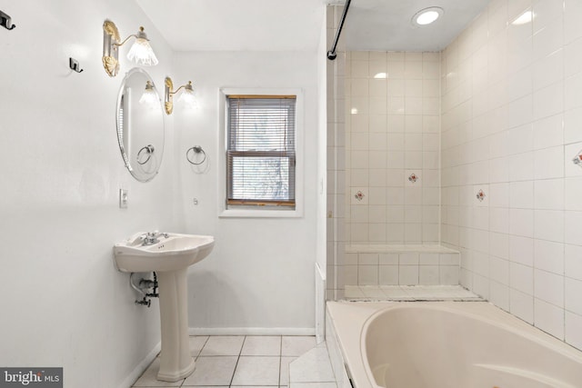 bathroom featuring tile patterned flooring and tiled shower / bath