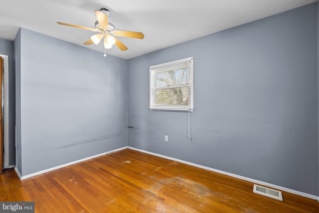 unfurnished room with hardwood / wood-style flooring and ceiling fan