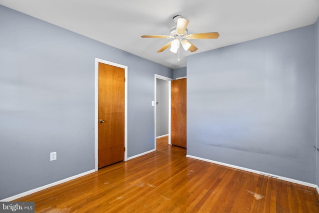 unfurnished bedroom featuring ceiling fan and hardwood / wood-style floors