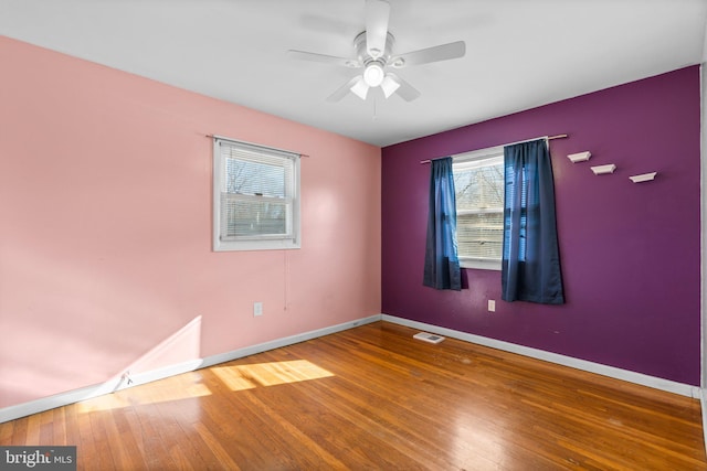 spare room with wood-type flooring and ceiling fan