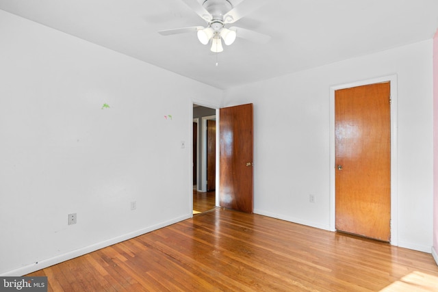 empty room featuring hardwood / wood-style floors and ceiling fan