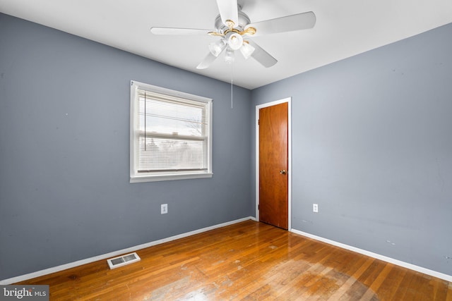 spare room featuring hardwood / wood-style floors and ceiling fan