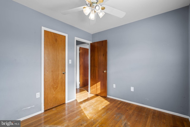 unfurnished bedroom featuring hardwood / wood-style flooring and ceiling fan