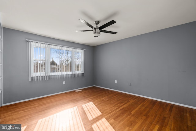 spare room featuring hardwood / wood-style floors and ceiling fan