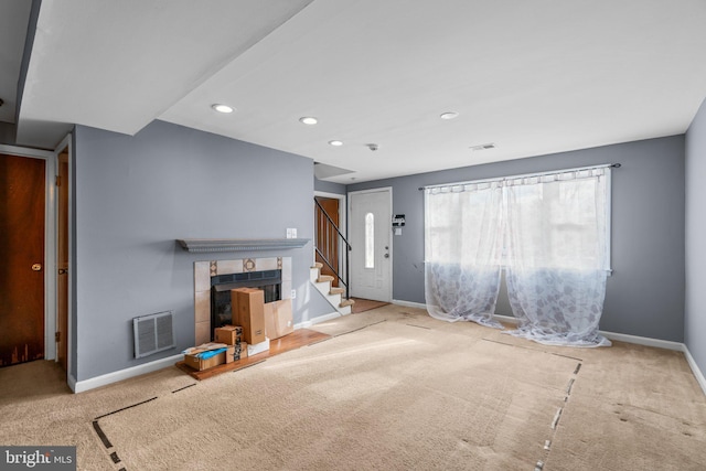 unfurnished living room featuring carpet floors and a fireplace