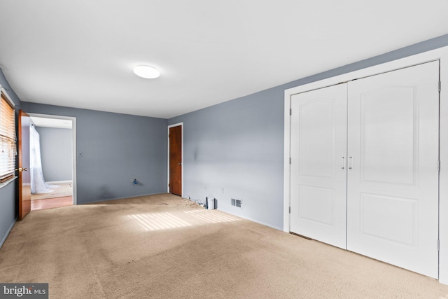 unfurnished bedroom with carpet floors and a closet