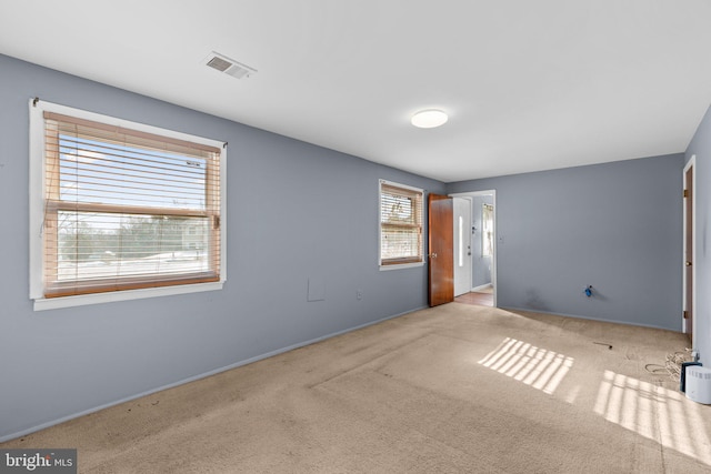 carpeted spare room with plenty of natural light