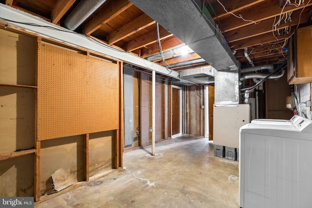 basement with washing machine and dryer and heating unit