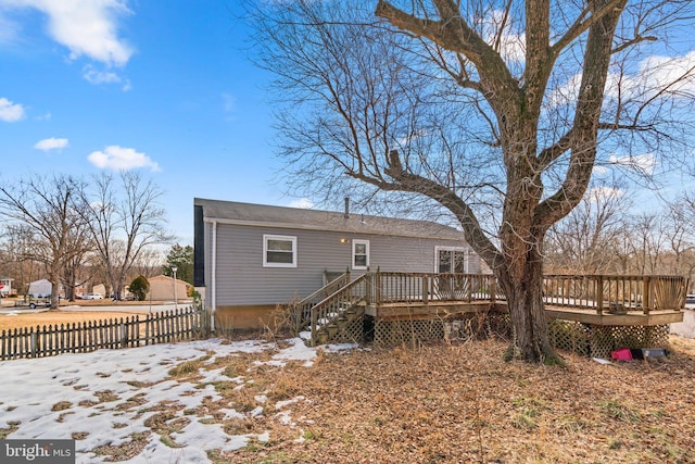 snow covered property featuring a wooden deck