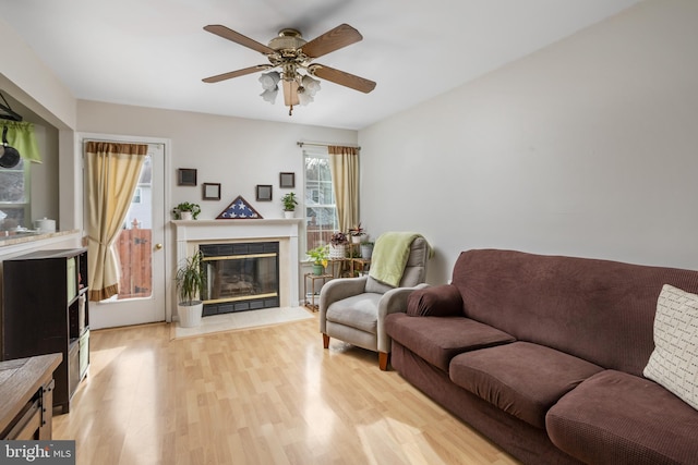 living room featuring ceiling fan and light hardwood / wood-style floors