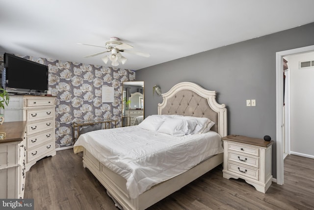 bedroom with dark hardwood / wood-style flooring and ceiling fan