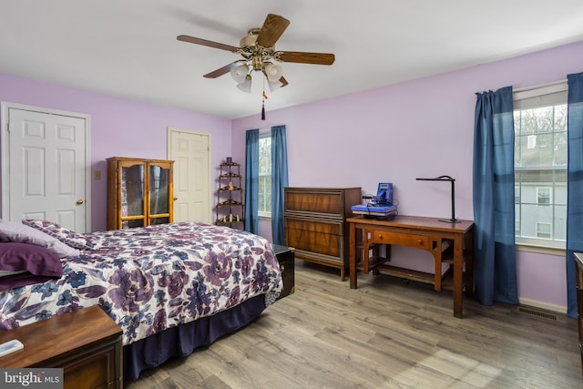 bedroom with wood-type flooring and ceiling fan