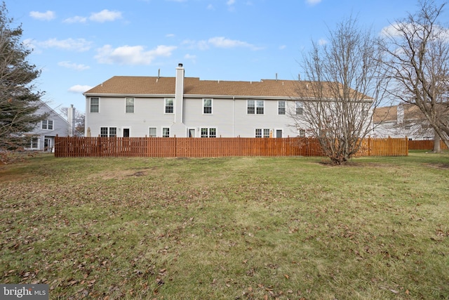 rear view of property with a lawn