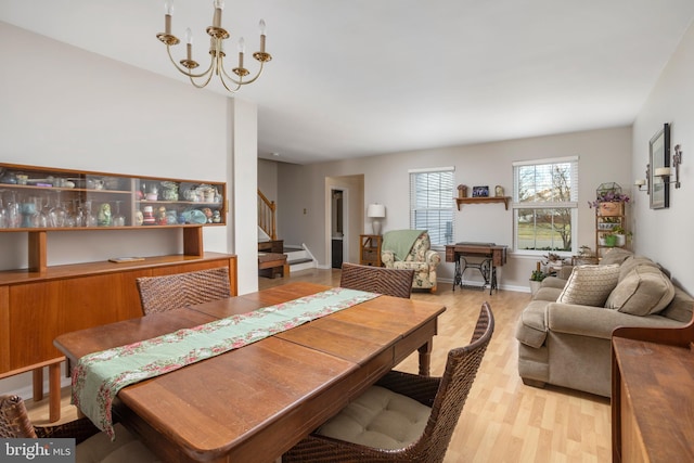 dining area with a notable chandelier and light wood-type flooring