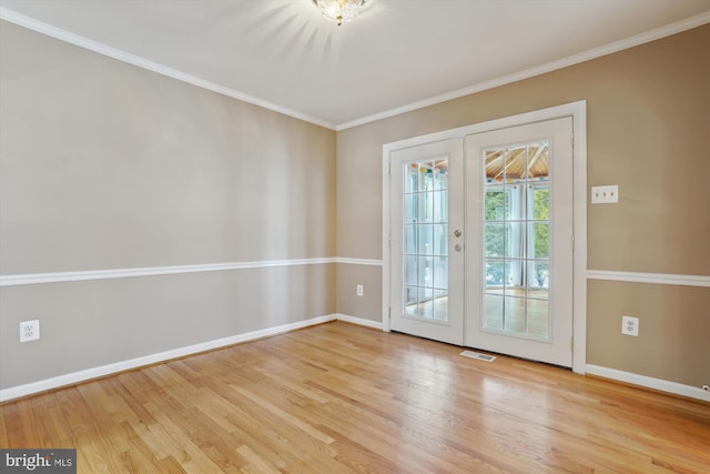 entryway with crown molding, light wood-type flooring, and french doors