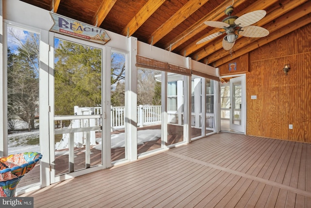 unfurnished sunroom with ceiling fan, wooden ceiling, and beam ceiling