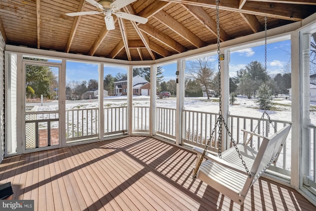 unfurnished sunroom featuring wood ceiling and ceiling fan