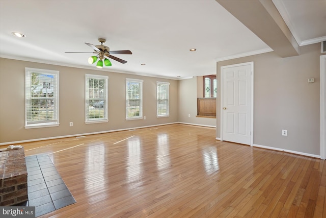 empty room with light hardwood / wood-style flooring, ornamental molding, and ceiling fan