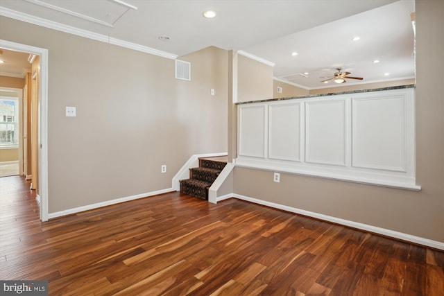 interior space with dark wood-type flooring, ornamental molding, and ceiling fan