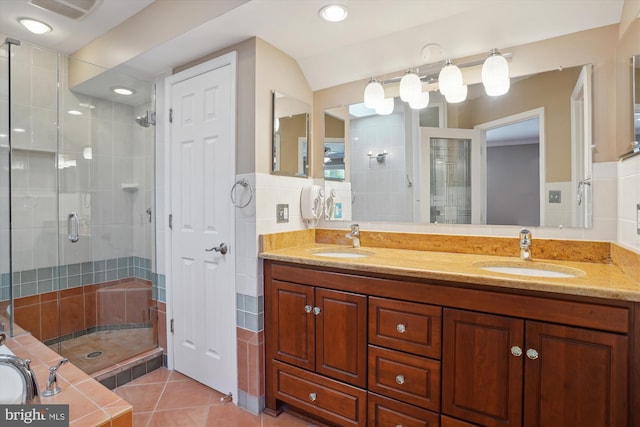 bathroom featuring vanity, tile patterned floors, and a shower with shower door