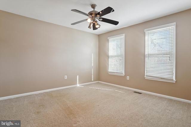 unfurnished room with light carpet and ceiling fan