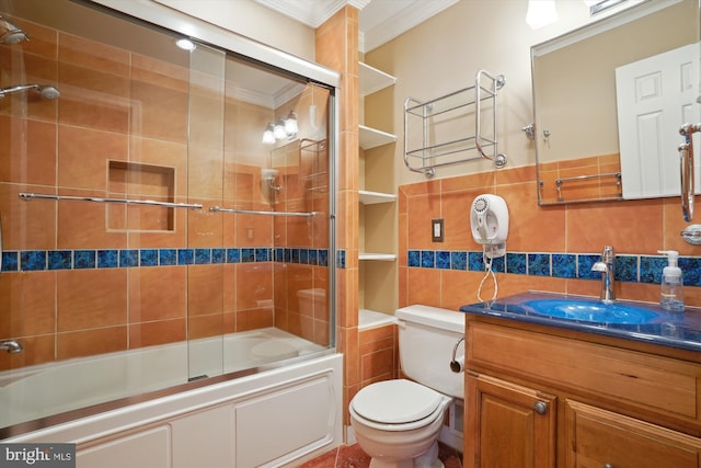 full bathroom featuring toilet, crown molding, shower / bath combination with glass door, tile walls, and vanity