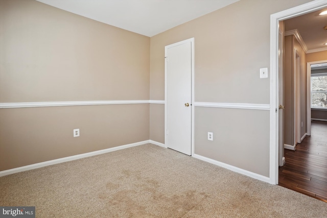 unfurnished bedroom with ornamental molding and carpet