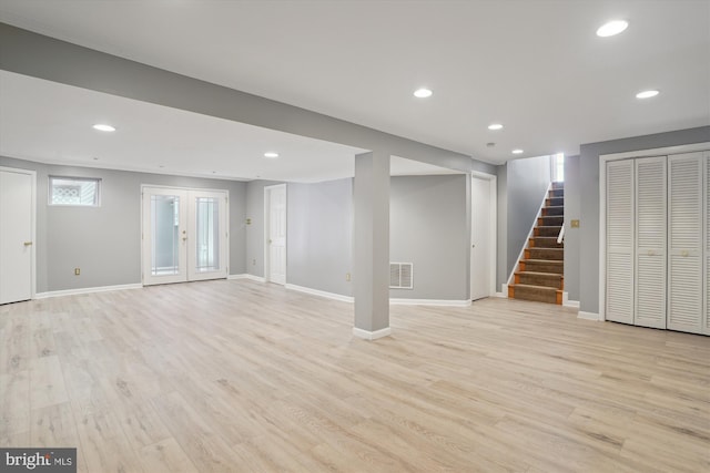 basement featuring french doors and light wood-type flooring